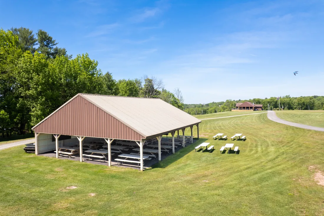 Covered outdoor pavilion with picnic tables for events